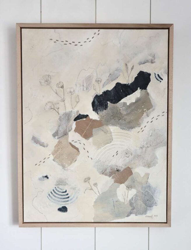 abstract painting hung on white boarded wall